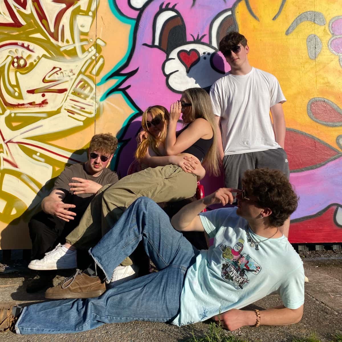 Joyride band photo in front of graffiti wall